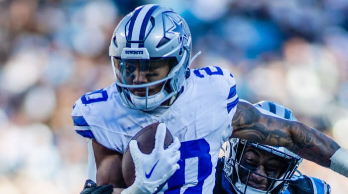 Cowboys running back Tony Pollard runs through a linebacker.